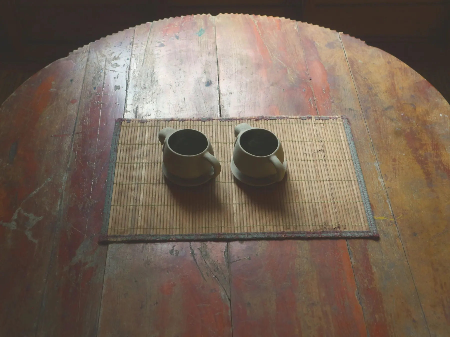 Two cups on a woven mat